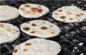 Chilean flatbreads being seared on a dry skillet over medium-low heat until golden.