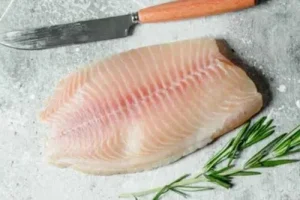Fresh fish Freshly cleaned white fish fillets being seasoned and prepared for the battering process.