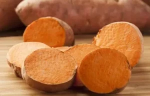 Sweet potatoes Fresh, firm sweet potatoes being prepared for baking, showing their characteristic dusty skin.