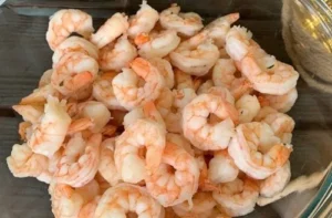 Shrimps Fresh, pink, shell-off shrimp piled high, ready to be seasoned with Merkén.