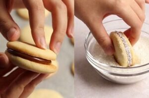 Assembling alfajores A person carefully spreading dulce de leche on a baked cornstarch cookie using a knife.