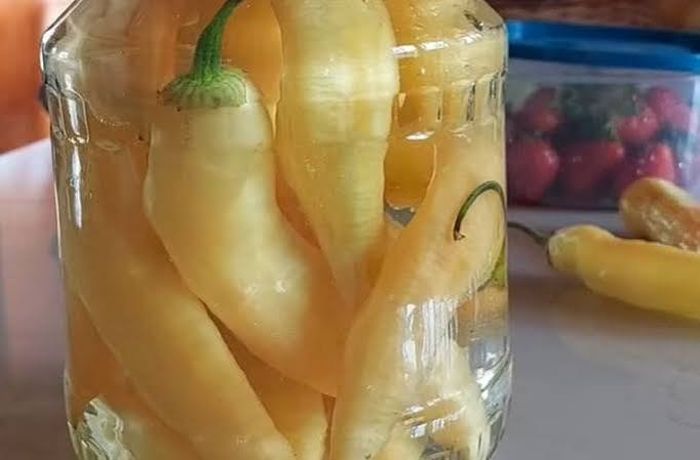 Chilean Pickled Chili Peppers — Homemade Ají en Escabeche with Apple Cider Vinegar Chilean pickled chili peppers (ají en escabeche) preserved in apple cider vinegar in glass jars — traditional Chilean condiment
