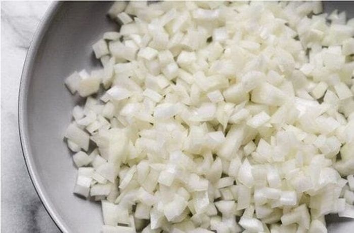 Step 1 — Onion, garlic, and paprika sautéed as the aromatic base Diced onion sautéed with garlic and paprika as the base for Chilean Papas con Chuchoca