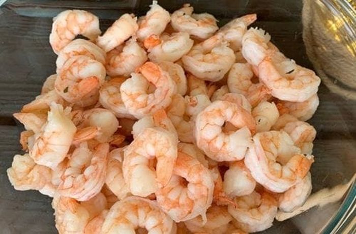 Step 3 — Fresh shrimp given a brief flash of heat in the spring onion sofrito before assembly Fresh pink shrimp cleaned and ready for the brief flash of heat before being assembled into Chilean shrimp and cheese empanadas