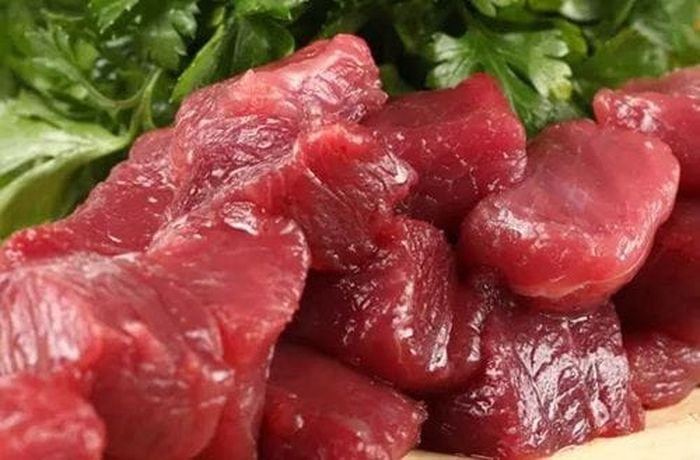 Step 1 — Llama meat simmered in salted water for 60 minutes, then shredded Raw llama meat pieces for Chilean calapurca — the traditional protein used in this Aymara ancestral soup
