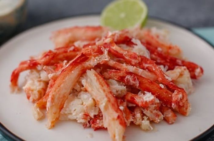 Shredded Chilean king crab meat mixed with cucumber, mayonnaise, and parsley for stuffed avocado