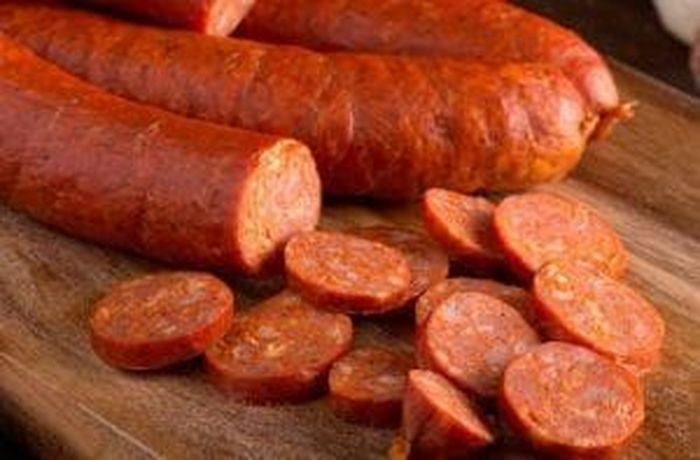 Smoked longaniza sausage sliced into 1 cm rounds for Chilean Cancato de Merluza Austral
