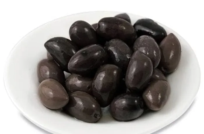 Green and black olives added to Chilean pichanga fría sharing platter