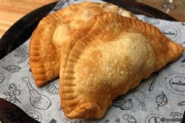 Chilean abalone empanadas (empanadas de locos) — fried and baked versions on a wooden board