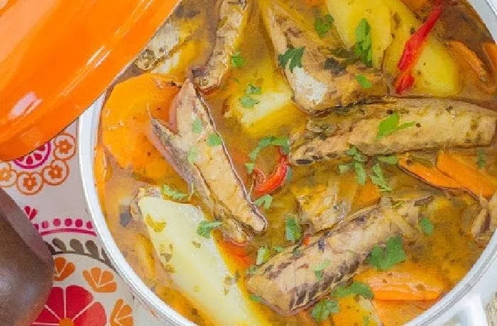 Chilean caldillo de jurel en tarro — canned jack mackerel fish stew with potatoes, carrots, and white wine served hot