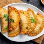 Chilean fried empanadas de jurel en tarro — golden crispy dough filled with canned jack mackerel and hard-boiled egg