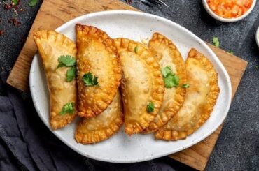 Chilean fried empanadas de jurel en tarro — golden crispy dough filled with canned jack mackerel and hard-boiled egg