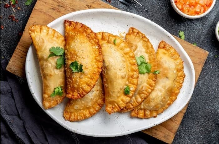 Chilean fried empanadas de jurel en tarro — golden crispy dough filled with canned jack mackerel and hard-boiled egg