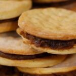 Chilean chancaca alfajores — traditional hojarasca cookies filled with chancaca, walnuts and raisins