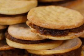 Chilean chancaca alfajores — traditional hojarasca cookies filled with chancaca, walnuts and raisins