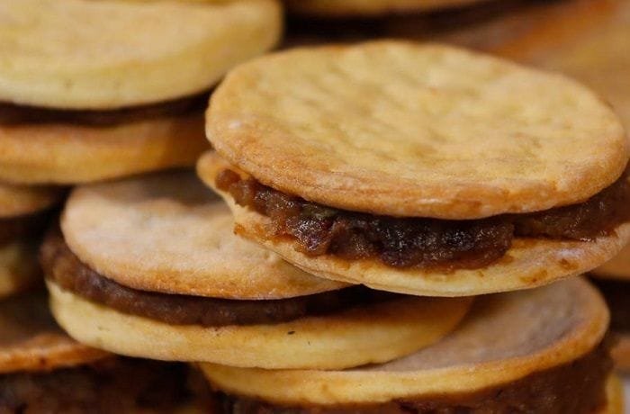 Chilean chancaca alfajores — traditional hojarasca cookies filled with chancaca, walnuts and raisins
