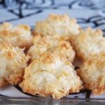Golden Chilean cocadas with a crispy shredded coconut crust on a baking sheet lined with parchment paper