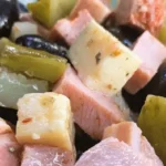 Chilean cold pichanga fría — deli meats, cheese, olives and pickles in a sharing platter