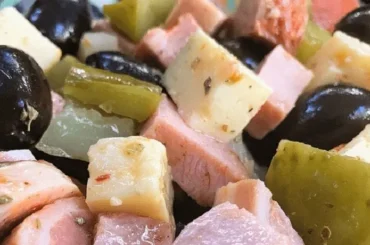 Chilean cold pichanga fría — deli meats, cheese, olives and pickles in a sharing platter