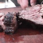 Chilean grilled huachalomo — juicy beef steak with golden crust from the parrilla