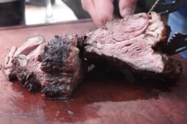 Chilean grilled huachalomo — juicy beef steak with golden crust from the parrilla
