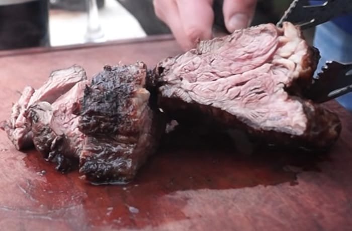 Chilean grilled huachalomo — juicy beef steak with golden crust from the parrilla