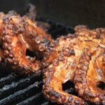 Chilean grilled octopus (pulpo a la parrilla) served over green quinoa pesto