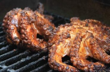 Chilean grilled octopus (pulpo a la parrilla) served over green quinoa pesto