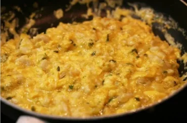 Chilean hake scrambled eggs with merkén — revuelto de merluza con huevos served with marraqueta bread