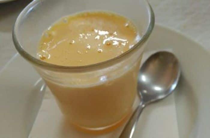 Thick, vibrant golden Chilean huevo mol made from egg yolks and sugar syrup, cooked to a smooth, dense consistency.