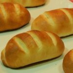 Chilean pan de leche — soft golden milk bread rolls fresh from the oven, perfect for breakfast