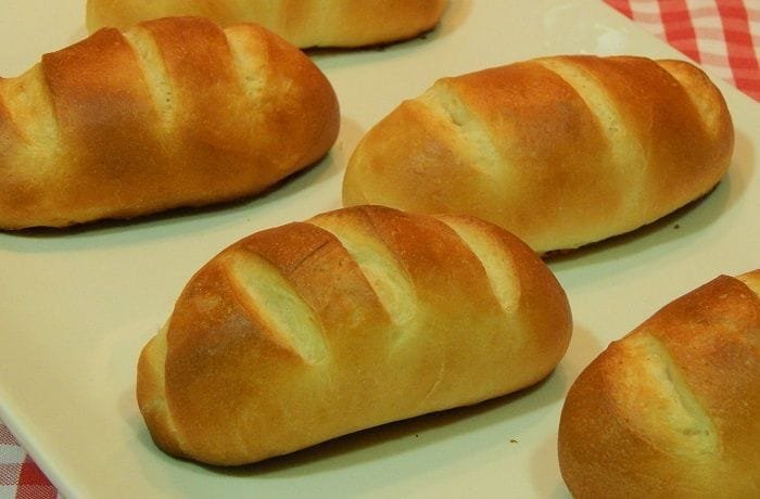Chilean pan de leche — soft golden milk bread rolls fresh from the oven, perfect for breakfast