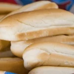 Chilean pan copihue (pan de completo) — homemade elongated bread used for completos and Chilean hot dogs, baked golden at 180°C