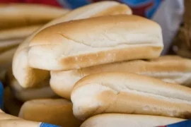Chilean pan copihue (pan de completo) — homemade elongated bread used for completos and Chilean hot dogs, baked golden at 180°C