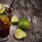 Chilean piscola cocktail — pisco and Coca-Cola over ice with limón de pica, Chile's national mixed drink