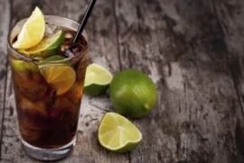 Chilean piscola cocktail — pisco and Coca-Cola over ice with limón de pica, Chile's national mixed drink