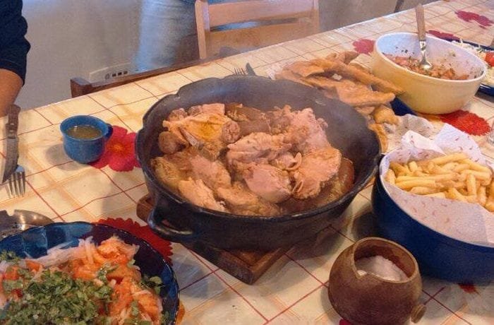 Chilean pollona de Los Ángeles — chicken, pork ribs and longanizas stew served hot with broth
