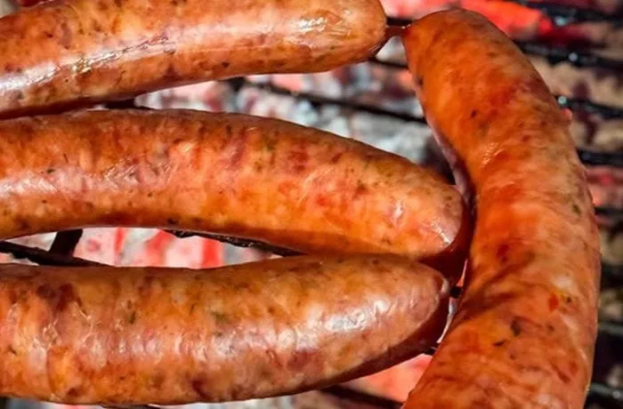Chilean San Carlos artisanal longaniza sausages — handcrafted with pork loin, paprika, and natural casing, grilled until golden