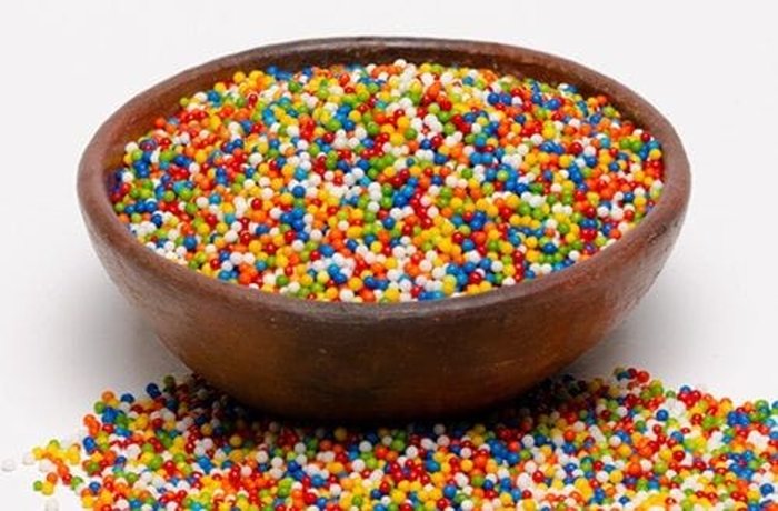 Colorful edible sprinkles (mostacillas) for decorating Chilean meringue cups