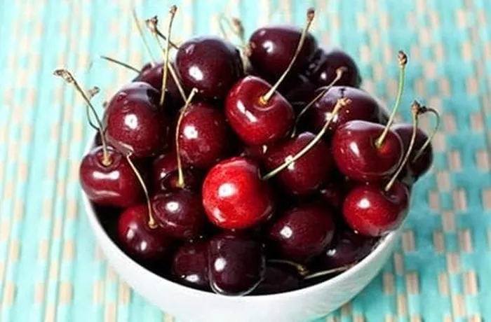 Fresh pitted cherries macerated with sugar and lemon for Chilean cherry kuchen filling