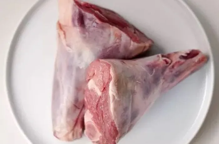 Lamb shanks (garrones de cordero) seasoned with merken, garlic and pepper before marinating