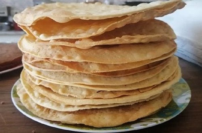 Baked mil hojas pastry rounds stacked and ready for assembly