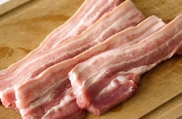 Pork bacon providing the 20% fat component for Chilean San Carlos longaniza — essential for juiciness and texture in the finished sausage