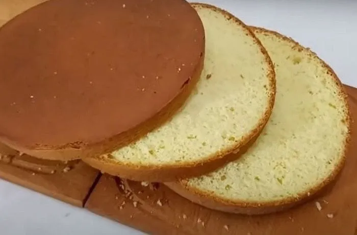 Freshly baked tres leches sponge (bizcocho) — golden, fully risen, and ready to be pierced and soaked with the three-milk mixture