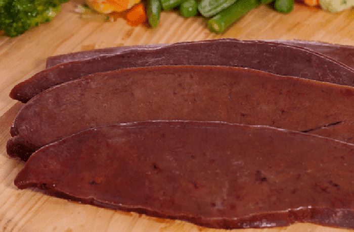 raw beef liver steaks ready to sear in hot olive oil for bistec de pana al ajo