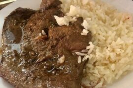 Chilean bistec de pana al ajo — garlic-marinated beef liver steaks served with rice