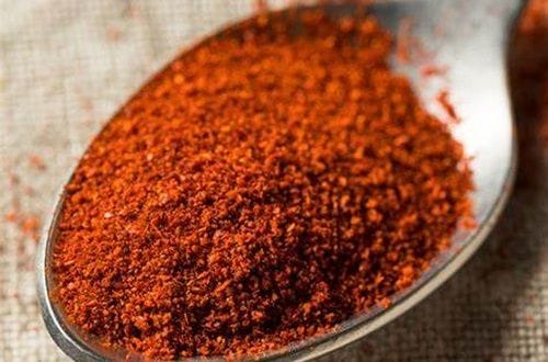 Ground ají de color powder (dried red pepper), the main seasoning in the recipe.