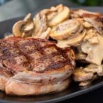 Bacon-wrapped filet mignon in red wine mushroom sauce