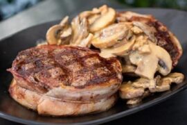 Bacon-wrapped filet mignon in red wine mushroom sauce