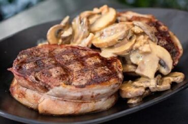 Bacon-wrapped filet mignon in red wine mushroom sauce